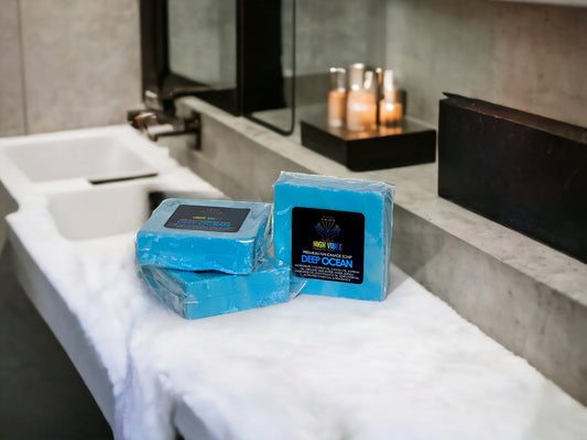 In the photo, there is the “Deep Ocean” High Vibee Soap. The soap is an ocean blue. The photo shows three of these soaps on top of a cloth on a beautiful bathroom counter.