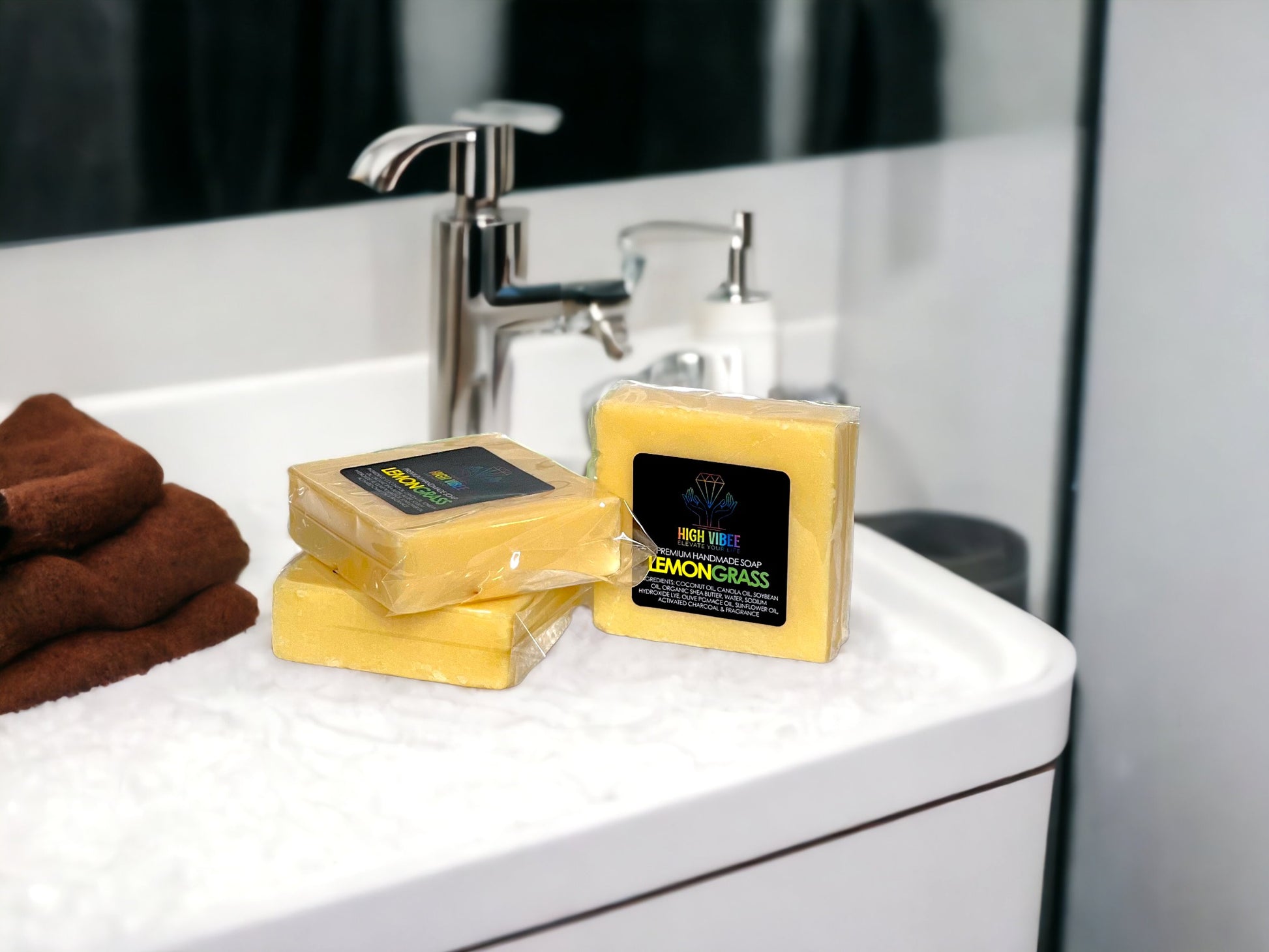 In the photo, there is the “Lemongrass” High Vibee Soap. The soap is a bright yellow. The photo shows three of these soaps on top of a cloth on a beautiful bathroom counter.