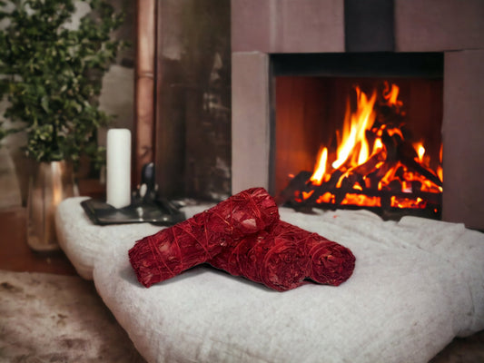 In this photo, High Vibee's "Dragonsblood Sage" is shown in front of a cozy fireplace. The sage has a deep red color.