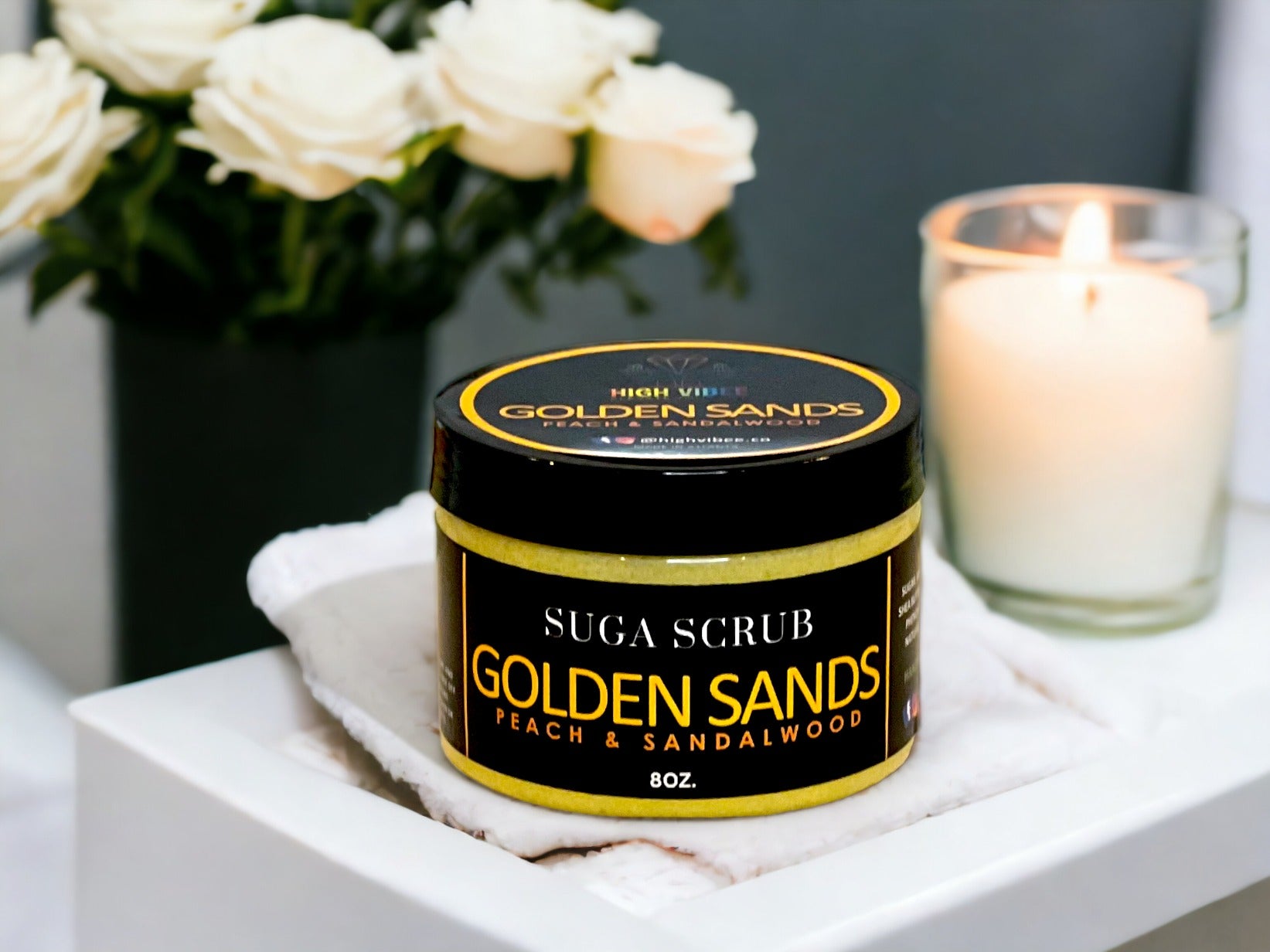 In this photo, there Is a jar of “Golden Sands” Sugar Scrub, scented with warm Peach & Sandalwood.