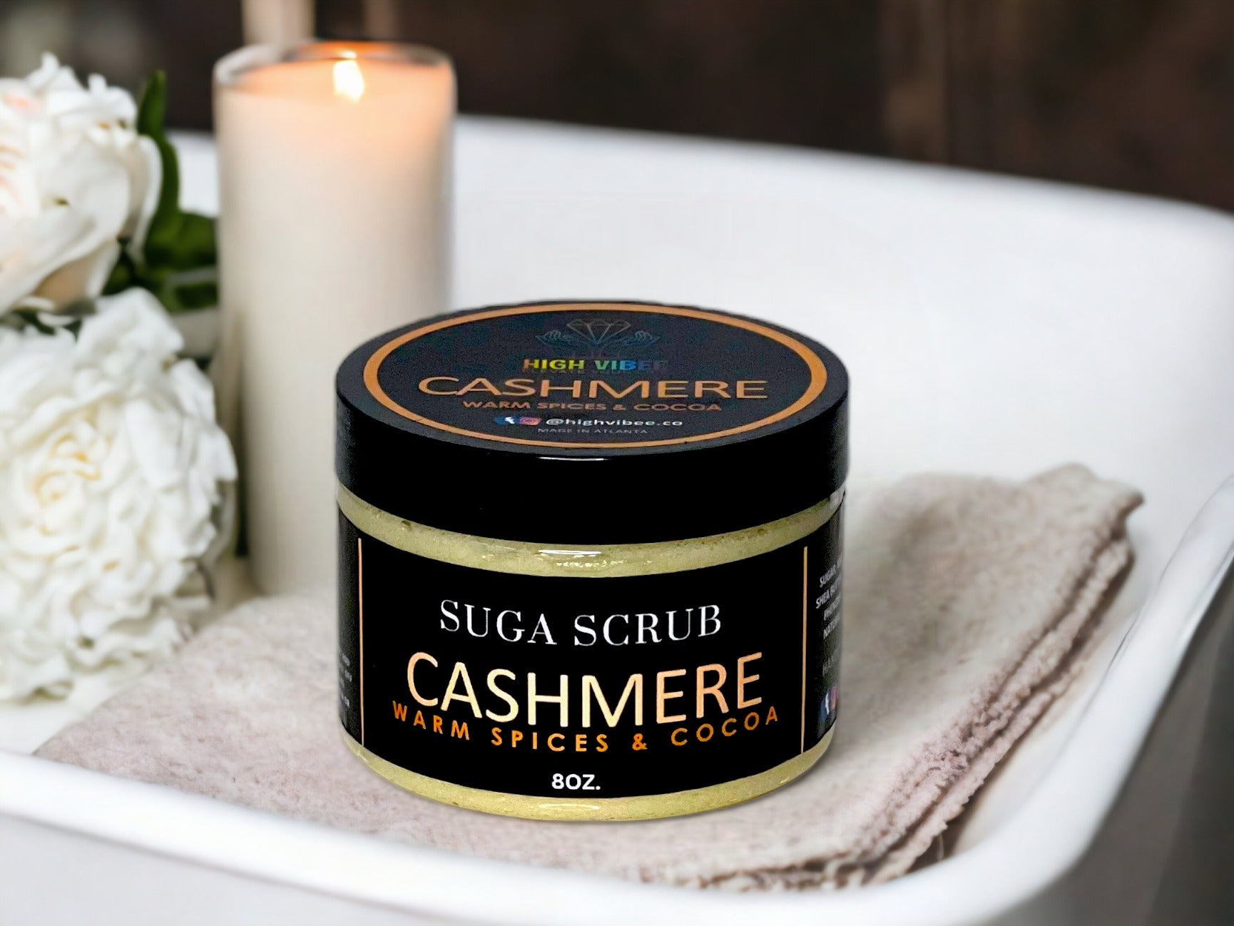 In this photo, there Is a jar of “Cashmere” Sugar Scrub, scented with warm spices & Cocoa.