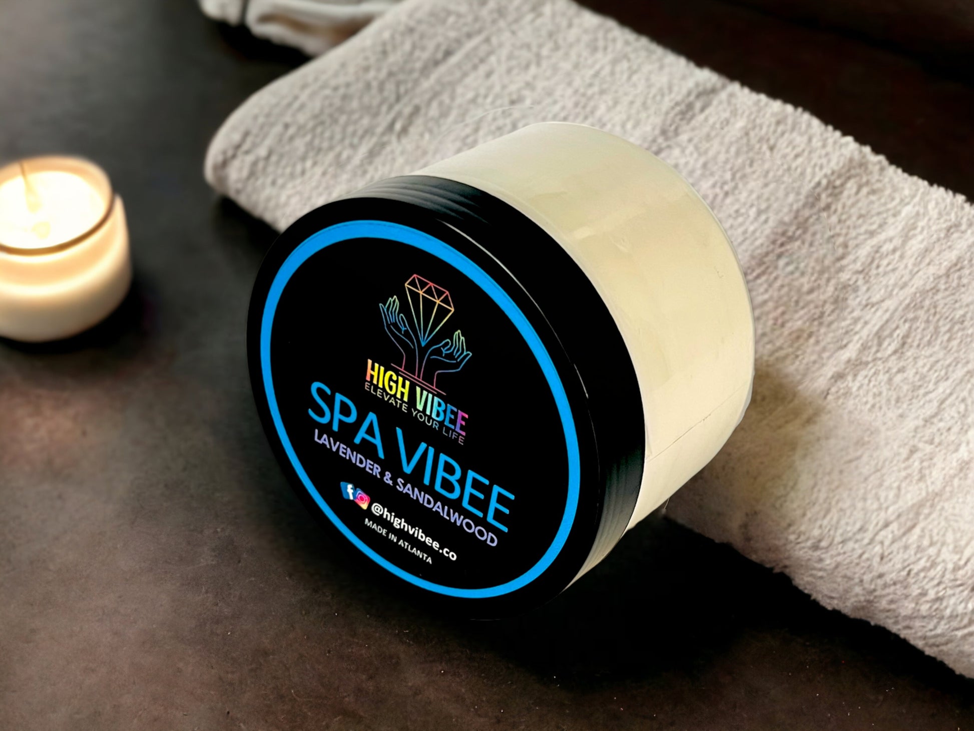 In this photo, there is a jar of High Vibee's “Spa Vibee” Body Butta scented with Lavender & Sandalwood.