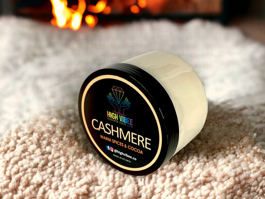 In this photo, there is a jar of High Vibee's “Cashmere” Body Butta scented with Warm Spices & Cocoa.