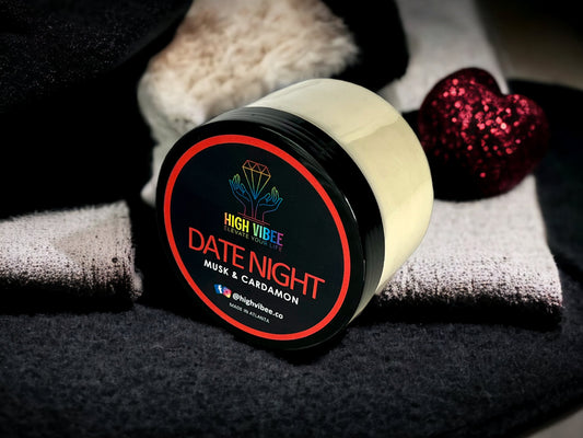 In this photo, there is a jar of High Vibee's “Date Night” Body Butta scented with Musk & Cardamon.