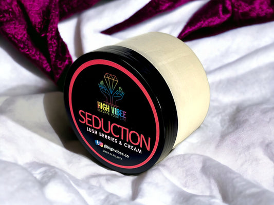 In this photo, there is a jar of High Vibee's “Seduction” Body Butta scented with Lush Berries & Cream.